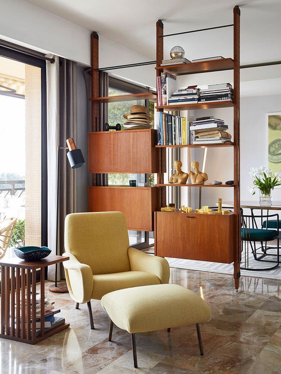 A wooden shelving unit with open shelves and closed cabinets for variative storage perfectly fits a mid century modern space