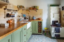 10 The kitchen features grass green cabinets with wooden countertops and a tan tile backsplash