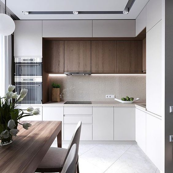 a compact kitchen with minimalist aesthetics and touches of natural wood for more coziness