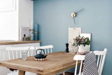 10 a serenity blue wall with a couple of shelves refreshes this dining nook and makes it cool