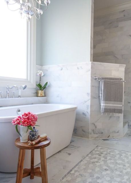 blue painted walls and grey marble tiles around the bathtub create a very peaceful look (via deeplysouthernhome)