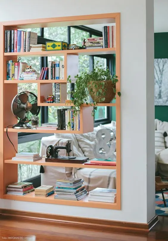 build in a shelving unit right into a wall, add a fun geometric shape to the shelves to delicately separate the spaces