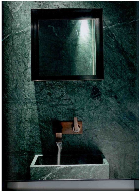 a green marble bathroom wall with a matching sink, a laconic square mirror for a natural yet refined feel