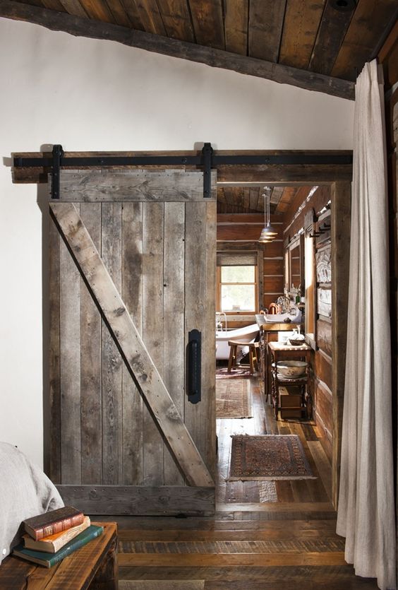 a sliding barn door of reclaimed wood is an ideal choice for a woodland or mountain cabin
