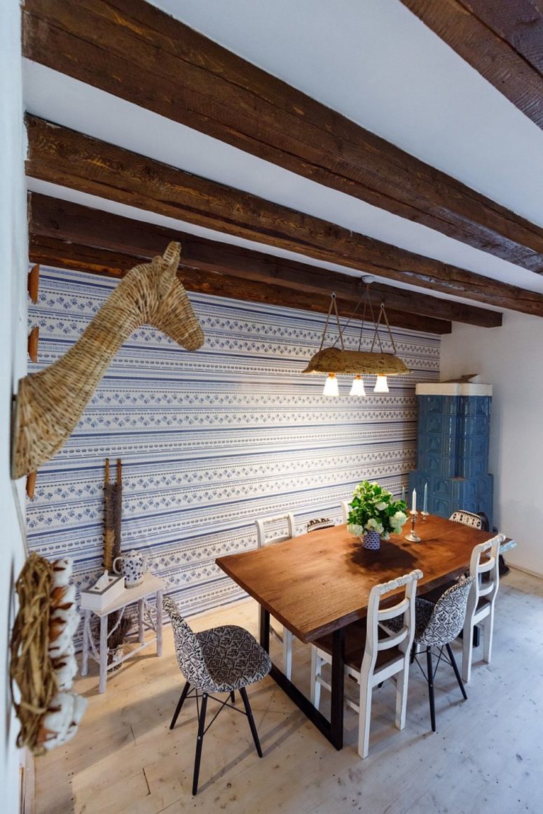 The dining space features a cool wall covered with traditional fabric and matching chairs, wow
