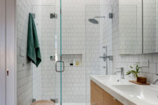 12 The shower space is done in white tiles with glass for a seamless look