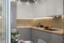 12 a minimalist kitchen fully illuminated with a large bubble chandelier and some built-in lights