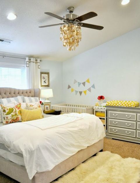 a modern farmhouse shared master bedroom and nursery space with a crib and a changing table
