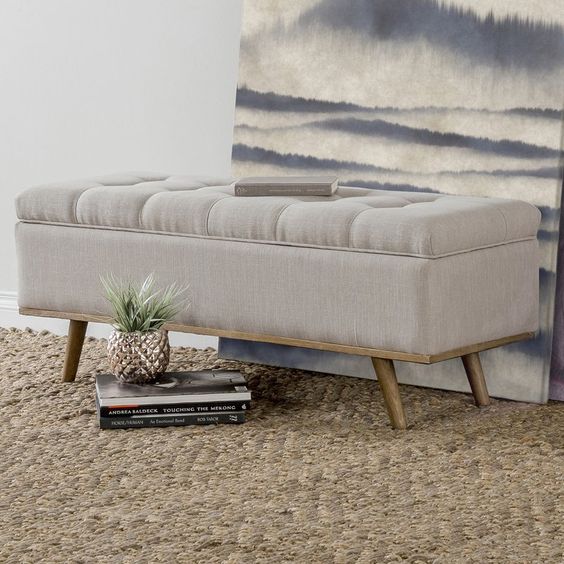 a cute fully upholstered bench or ottoman with a hidden storage space is great to add coziness to the entryway