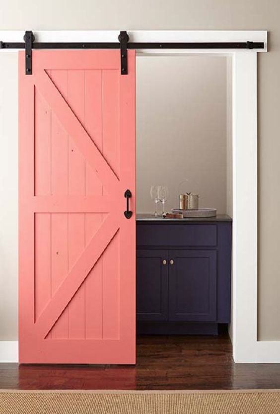 why not paint your barn door in some bold shades like coral to make a colorful statement in the interior