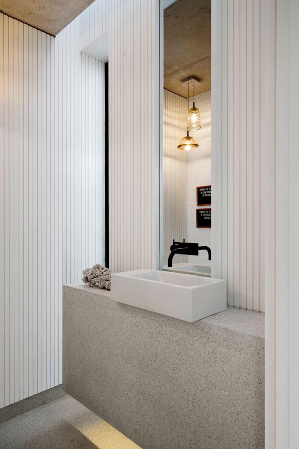 White wooden slabs and a stone sink stand create an elegant and modern feel