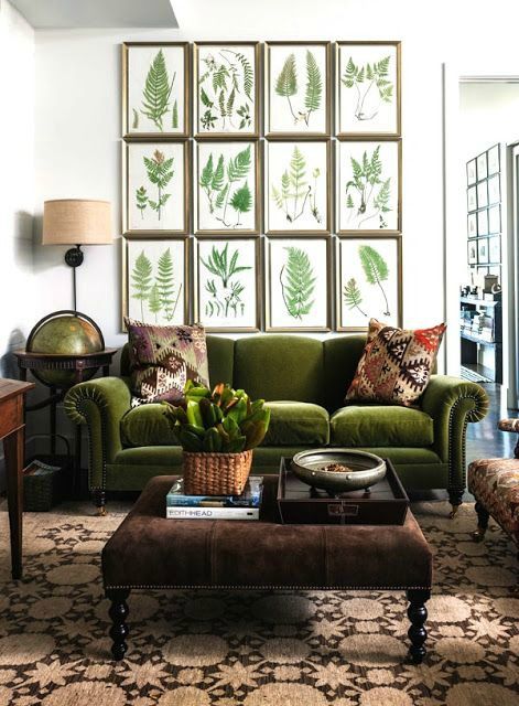 a combo of green velvet, greenery gallery wall and browns makes this space feel natural and welcoming