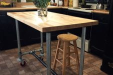 14 a portable industrial kitchen island of metal pipes on casters and a butcher block as a top can be DIYed by you