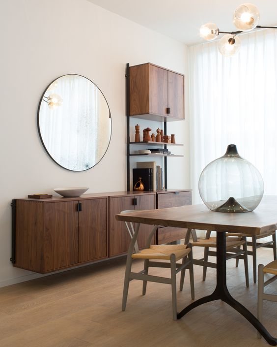 a floating credenza and additional cabinets take wall space no floor space