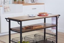 15 a portable kitchen island of blackened metal, casters and some wooden tops plus two shelves for comfy storage