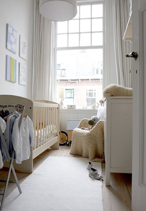 a window takes a whole wall and there's a pendant lamp to make the nursery lighter
