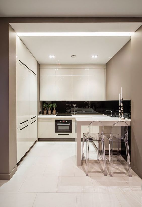 built-in lights and glossy cabinets that reflect the light and make the space even bigger