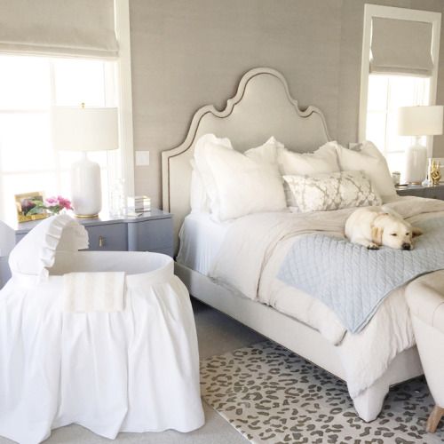 a preppy bedroom with a vintage feel and a fabric covered crib by the bed