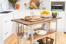 16 a simple industrial kitchen island of steel and reclaimed wood on casters features two open shelves