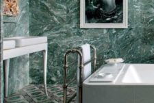 16 green marble tiles on the walls and mosaic tiles on the floor for a bold eclectic look