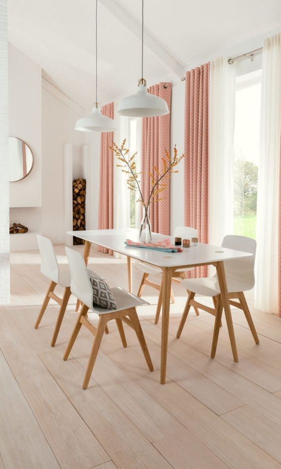 Pink printed and white grommet curtains for a soft colorful touch and a cozy look in the dining room