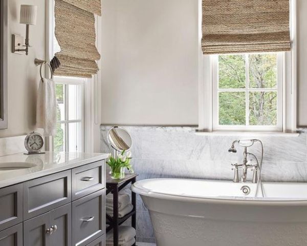 a simple marble tile backsplash adds chic to a modern farmhouse bathroom
