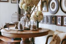 17 a vintage wooden table, a chair and a gallery wall with vintage family photos for a refined space