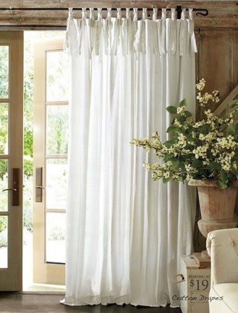 An ethereal tab-top white curtain is an ideal piece for a French countryside space