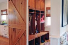 18 a light-colored sliding barn door can be used to hide a small mudroom or another functional space