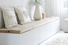 18 a modern white bench with a wooden plank top and much storage space inside