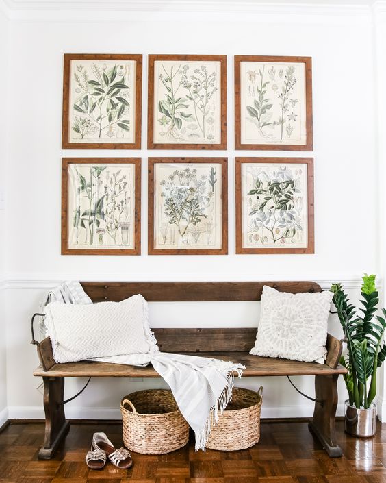 a wooden bench, wicker baskets and a gallery wall with botanical art for a natural feel