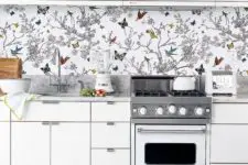 18 to avoid a boring look in an all-white kitchen, rock a colorful wallpaper backsplash with butterflies and birds