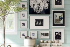 19 a country house entryway with mint walls, baskets and a gallery wall in black and white for a statement