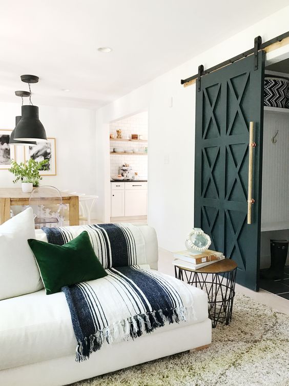 Paint the barn door black and add a gold handle to make it look more glam like and chic