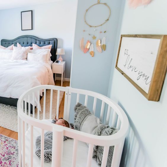 a modern master bedroom with a boho crib nook that perfectly fits the space sprucing it up a little