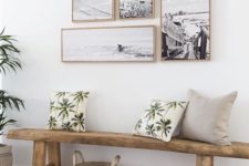 20 a natural space with a wooden bench and a black and white gallery wall with matching frames