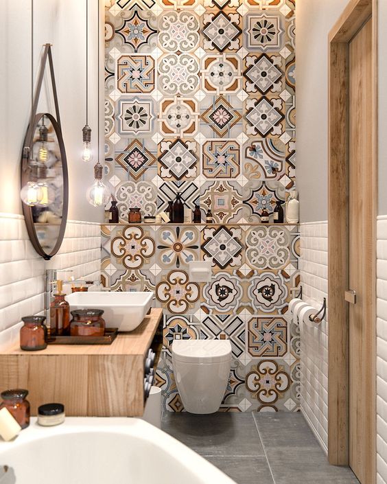an accent mosaic wall changes the whole look of this very small bathroom