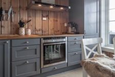 20 graphite grey vintage-looking cabinets are softened and warmed up with light-colored wood