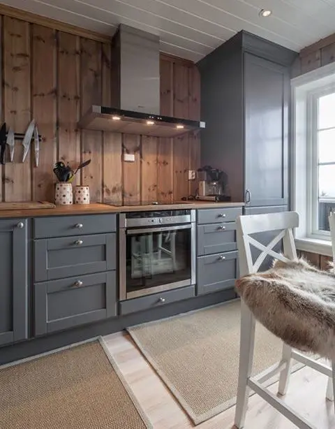 graphite grey vintage-looking cabinets are softened and warmed up with light-colored wood