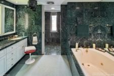 21 a large modern bathroom clad with green marble tiles is made fresher with white furniture and cabinets