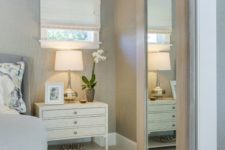 21 a light-colored barn door with a large mirror can be used for dressing up in the bedroom