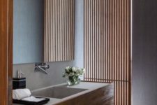 21 a vertical wooden plank screen separates the bathroom into two parts but lets light in