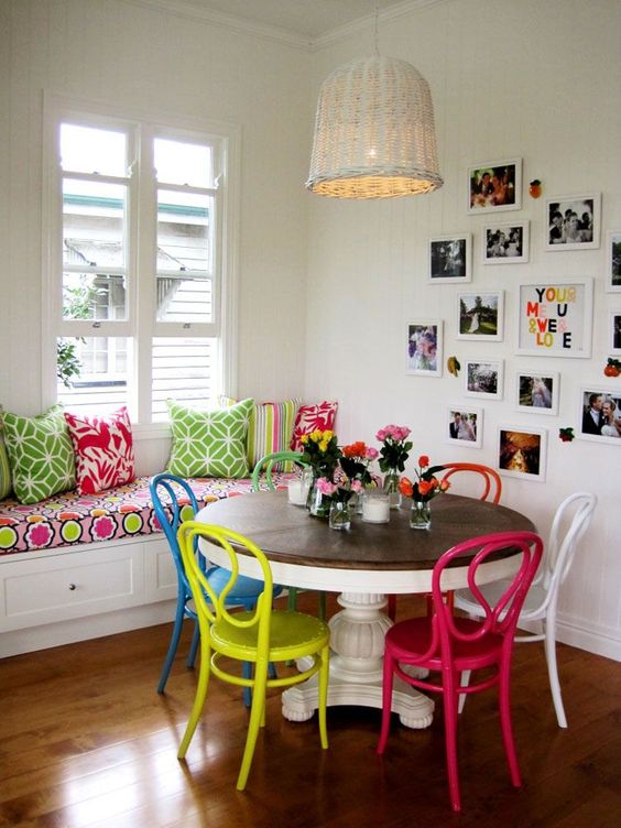 a vintage rustic dining table plus same chairs but in different bold colors to rock