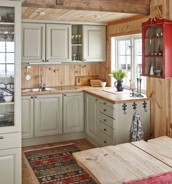 rustic vintage off-white cabinets, light-colored wooden countertops and backsplashes for a welcoming feel