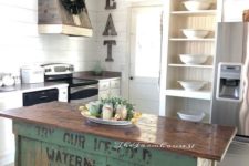 22 a vintage industrial kitchen island of wood with a green base of crates that looks very eye-catchy