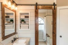 23 a sliding barn door with a mirror insert is a great idea for the bathroom as the mirror is a must for such a space