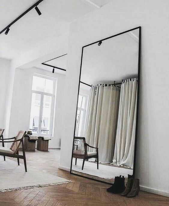 an oversized vertical floor mirror will add visual height, can be used for dressing up and will visually enlarge the space