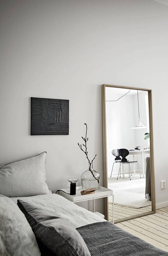 a simple vertical mirror in a wooden frame is always a good idea and it will fulfill many functions