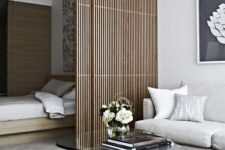 a very sleek bamboo screen is in absolute harmony with the minimalist aesthetics of this space