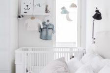 25 a small Scandinavian bedroom with a baby’s nook with a crib, shelves, a mobile and a wardrobe